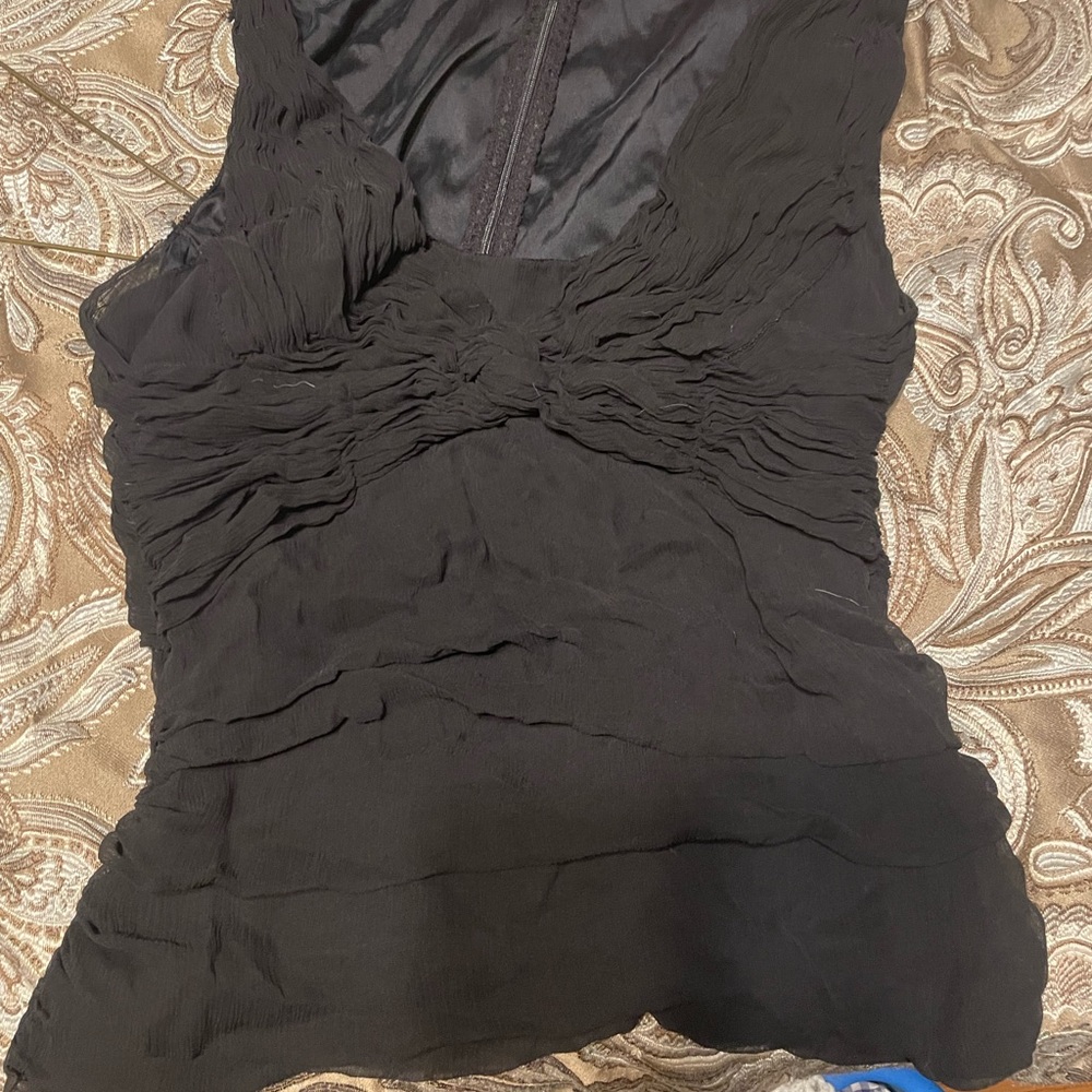 Black tank top with ruffles.